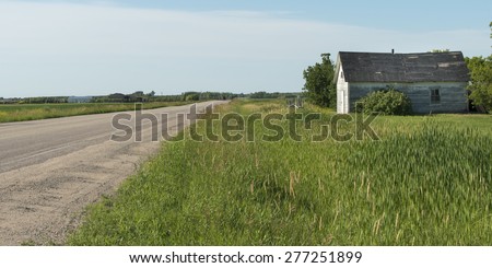 Road passing through a prairie field, East Selkirk, Manitoba, Canada