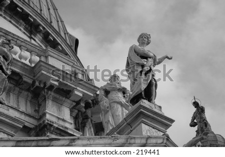 Low angle view of sculptures mounted on pillars, Venice, Italy (black and white),