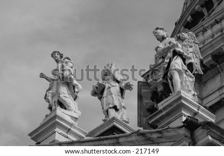 Low angle view of sculptures mounted on pillars, Venice, Italy (black and white)