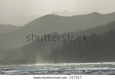 Waves on the surface of water with a mountain range in the background, Kauai Island, Hawaii,