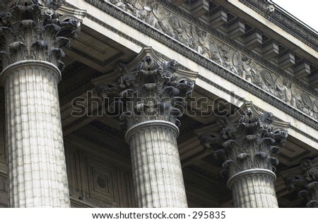 Low angle view of the top of ornate columns outside a building, Paris, France,