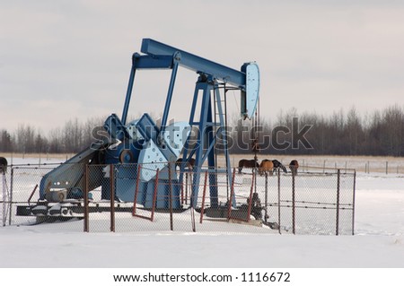 Oil Well in Field of Snow in Alberta Canada