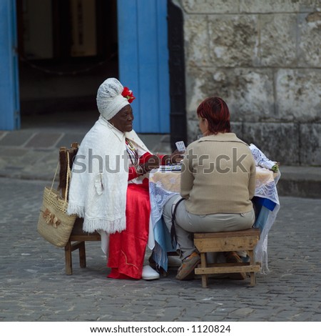 Fortune teller sitting on the street telling a person their future, Havana, Cuba