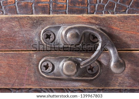 The lock of a wooden casket close up