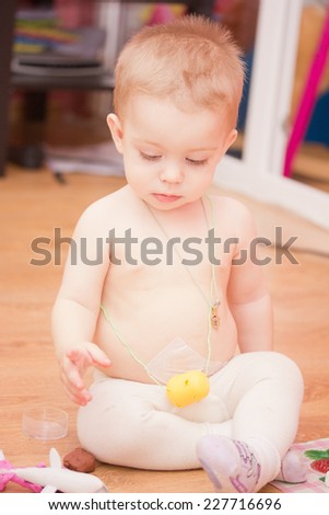 Top view of little boy playing on the floor