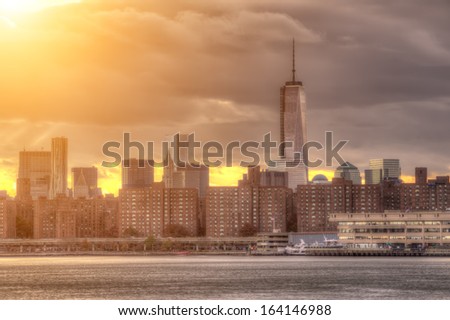 NEW YORK - NOVEMBER 8, 2013: Freedom Tower at beautiful sunset with East River and Manhattan Skyline in New York. The Freedom Tower is the primary building of the World Trade Center complex in NYC.