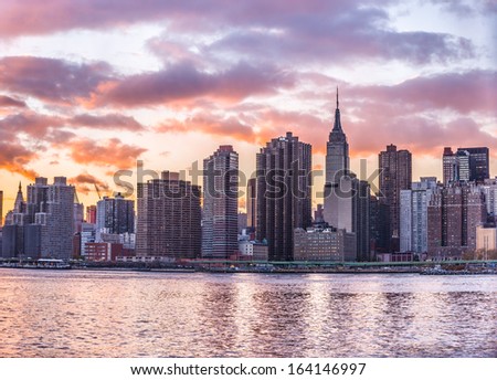 NEW YORK - NOVEMBER 8: Empire State Building and Manhattan Skyline on November 8, 2013 in New York. The Empire State Building is a 102-story skyscraper and is a very popular landmark in the US.