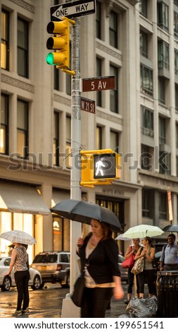 NEW YORK - JUNE 13: rainy day on Fifth Avenue on June 13, 2014 in New York. Fifth Avenue is a major thoroughfare that runs through Manhattan, New York City.
