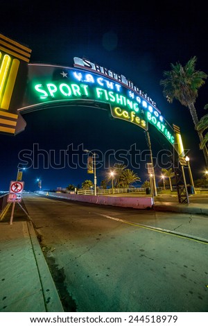 SANTA MONICA - JAN 14, 2015: Famous Santa Monica Yacht Harbor Sign - Entrance to Santa Monica Pier on Ocean Avenue in LA at Night. Santa Monica is a beachfront city in Los Angeles California.
