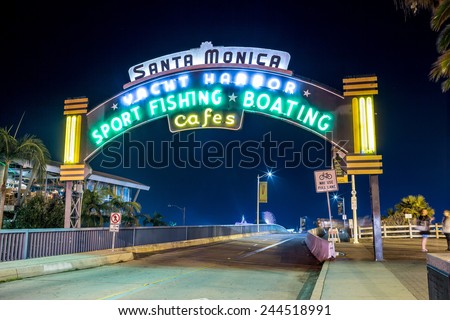 SANTA MONICA - JAN 14, 2015: Santa Monica Yacht Harbor Sign at Night - Famous Entrance to Santa Monica Pier on Ocean Avenue in LA. Santa Monica is a beachfront city in Los Angeles California.