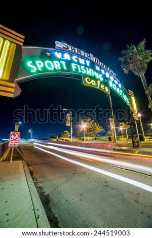 SANTA MONICA - JAN 14, 2015: Santa Monica Yacht Harbor Sign in Los Angeles California at Night with Long Exposure Car Light Streak. Santa Monica is a beachfront city in Los Angeles California.