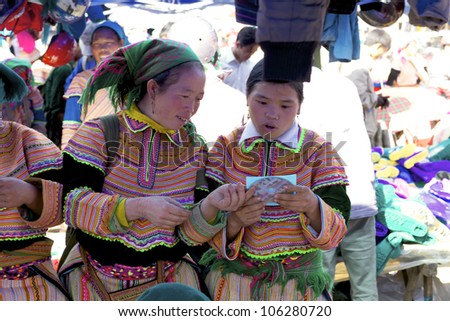 BAC HA, VIETNAM - NOV 21: Unidentified woman of the Flower H\'mong Ethnic Minority People at market on November 21, 2010 in Bac Ha, Vietnam. H\'mong are the 8th largest ethnic group in Vietnam
