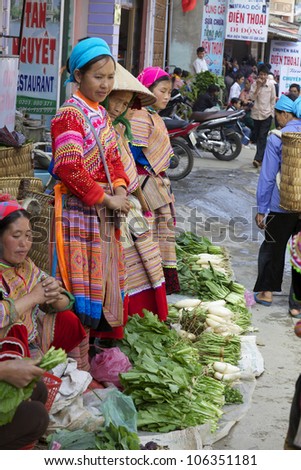 BAC HA, VIETNAM - NOV 21: Unidentified women of the Flower H\'mong Ethnic Minority People selling produce on November 21, 2010 in Bac Ha, Vietnam. H\'mong are the 8th largest ethnic group in Vietnam