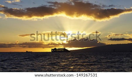 Cruise ship against sunset on Ocean in Hawaii