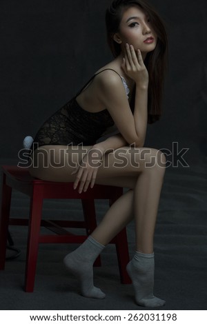 Beautiful asian model on red chair wearing lingerie