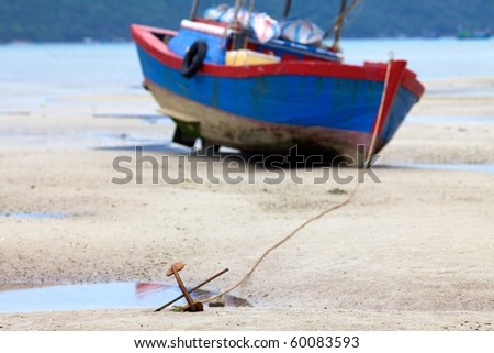 Fishing boat stuck in sand when tide goes out