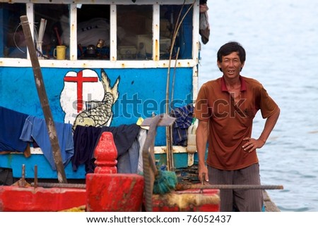 CON DAO ISLAND, VIETNAM - JUNE 26: Unidentified Vietnamese Man on fishing boat June 26, 2010 at Con Dao Island, Vietnam.  Each year fishing boats bring in more than 10,000 tons of seafood to the port.