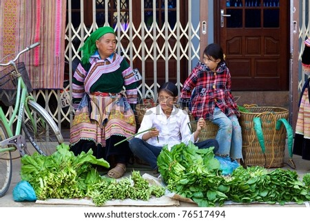 BAC HA, VIETNAM - NOV 21: Unidentified women of the H\'mong Ethnic Minority People sell produce on November 21, 2010 in Bac Ha, Vietnam. H\'mong are the 8th largest ethnic group in Vietnam