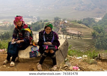 SAPA, VIETNAM- NOV 21: Two unidentified women of the Black H\'mong Ethnic Minority People sit on hill in Sapa, Vietnam on November 21, 2010.  H\'mong are the 8th largest ethnic group in Vietnam