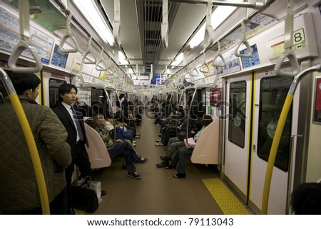 TOKYO- NOVEMBER 17: Rush hour commuters riding the Tokyo metro transit system in Tokyo, Japan on November 17, 2009.  The transit system carries almost an average of 8 million passengers daily.