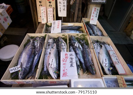 TOKYO- NOVEMBER 20: Seafood buyers at the Tsukiji Wholesale Seafood and Fish Market in Tokyo Japan on November 20, 2009. Tsukiji Market handles over 2000 metric tons of seafood per day.