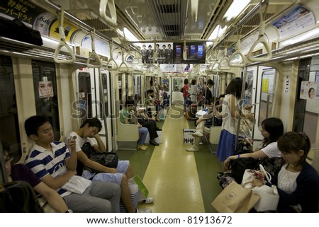 TOKYO- JULY 3: Commuters ride Tokyo metro transit system in Tokyo, Japan on July 3, 2011. The transit system carries 8.7 million passengers per day and began operations on December 30, 1927.