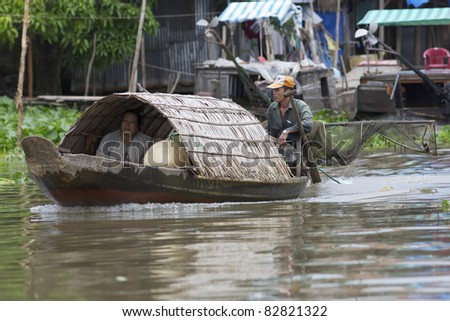 CAN THO, VIETNAM- MAY 28: A Vietnamese couple travel by boat in Mekong Delta in Can Tho, Vietnam on May 28, 2011. Mekong delta region encompasses a large portion of southeastern Vietnam of 39,000 km2