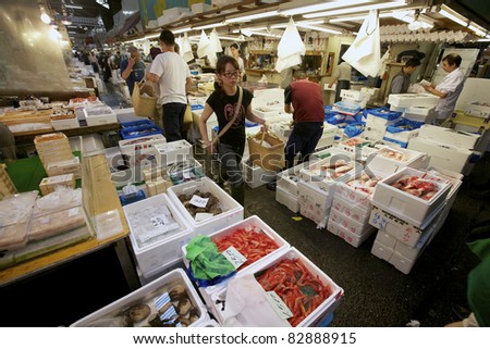 TOKYO - JULY 4: Seafood vendors at the Tsukiji Wholesale Seafood and Fish Market in Tokyo Japan on July 4, 2011. Tsukiji Market is the biggest wholesale fish and seafood market in the world.