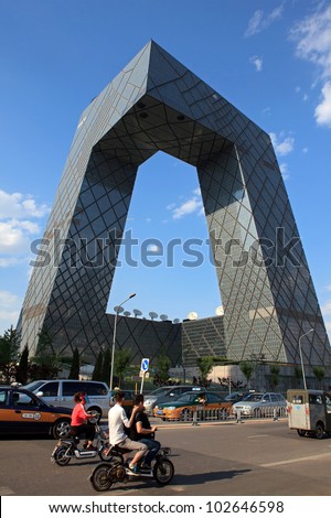 BEIJING-MAY 15: People cycle around China Central Television (CCTV) Headquarters, a 234 m and 44-storey skyscraper, on May 15, 2012 in Beijing downtown, China. CCTV is the National TV station of China