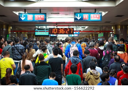 BEIJING-OCT 2: Passengers crowd a subway station during National Day holiday on Oct. 2,2013 in Beijing, China. Beijing\'s 14 subway lines carry over 8.5 million passengers on an average weekday.