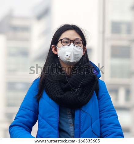 Beijing-Dec 8: Woman With Face Mask Is Seen On Dec 8, 2013 In Beijing, China. 104 Cities In China Suffered From Severe Air Pollution On Dec 7, With Beijing Among That Hit The Hardest