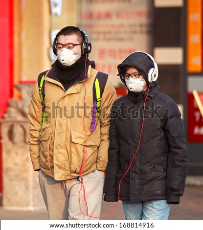 BEIJING, CHINA-DEC 25, 213: People is seen with face mask; a high-ranking environmental official has estimated cleaning up China\'s air pollution will cost 1.75 trillion yuan between 2013 and 2017