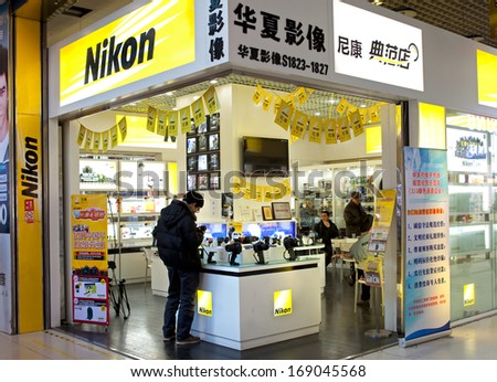 BEIJING, CHINA - DECEMBER 28, 2013: Shoppers are seen at a Nikon store; Nikon Corporation, also known as Nikon, is a Japanese multinational corporation specializing in optics and imaging products.