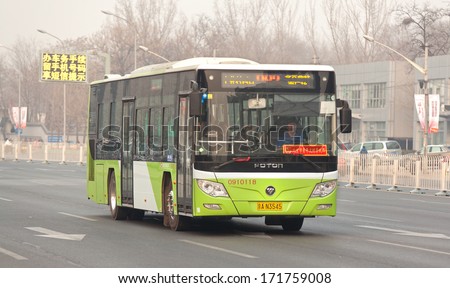 BEIJING, CHINA - JANUARY 4, 2014: People ride a Foton bus. Beiqi-Foton Motor Co., Ltd. (Foton), plans to sell 3 million vehicles annually by 2020 with sales revenues of $52 billion