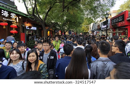 BEIJING, CHINA - OCTOBER 3, 2015: People crowd Nanluoguxiang, an ancient part of the city, during the National Day holiday, the 66th anniversary of the founding of the People's Republic of China.