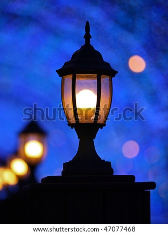 Romantic lanterns at night under blue bright background, Bokeh