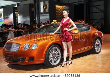 BEIJING - APRIL 29: A model stands beside a Bentley Continental GT Design Series China at the 2010 Beijing International Automotive Exhibition (Auto China 2010) on April 29, 2010 in Beijing, China.