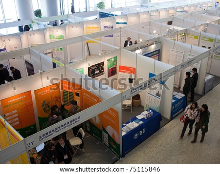 BEIJING - MARCH 24: Visitors look at posters and exhibition during the 3rd Annual International Congress of Antibodies on March 24, 2011 in Beijing, China.