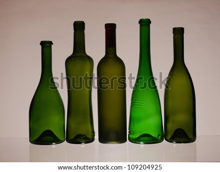 Five empty wine bottles  on  brown   background.