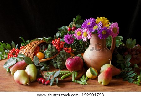 Composition with variety  fruits, flowers and leaves in basket isolated on black