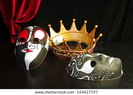 Crown and two masks on black