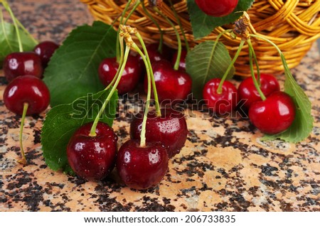 Cherries  with water drops on granite table