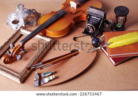 Attributes of arts. Violin, frame, palette, brushes, paints, mask, old camera