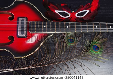 Jazz guitar and mask on black