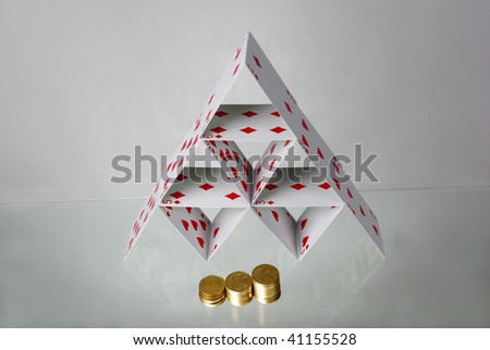 Finance pyramid.Pyramid of play cards and coins