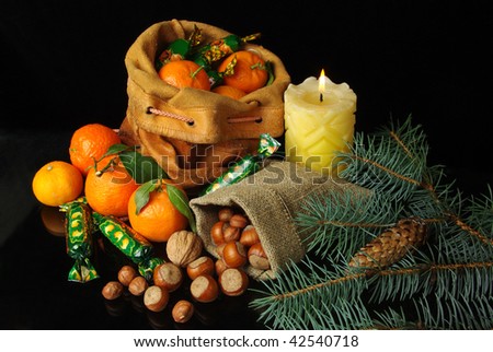 Presents of St. Nikolaus.Nuts, tangerines, candies in the Bag.Isolated in  black