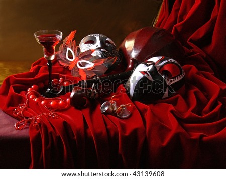 Masquerade still-life.Colorful Venice masks, glass of wine and music instruments