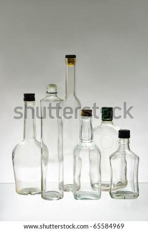Bottles of vodka on gray background