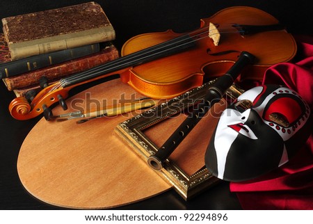 Attributes of Arts: music, painting, theater. Palette, violin,  mask, brushes, flute, frame, books, drapery