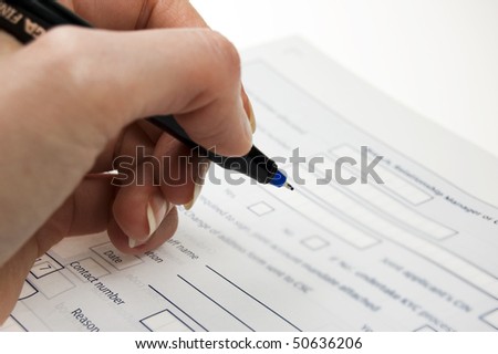 female hand signing voting form/application form